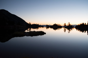 Sunrise lake in the Spanish Pyrenees, located at mountain hut JM Blanc, Aigüestortes i Estany de Sant Maurici national park