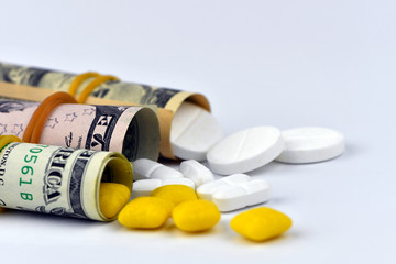 Dollar rolled up with pills flowing out isolated on white background, high costs of expensive medication concept. Copy space - image