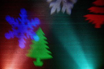 Blue and red rays of light on a black background.  Colored snowflakes and christmas trees