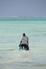 a man entering the sea to practice diving