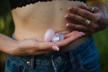 Female hands holding two yoni eggs for vumfit, imbuilding or meditation are made from pink quartz...