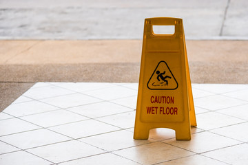 warning beware accident concept, The image of yellow caution wet floor plastic sign put on the...