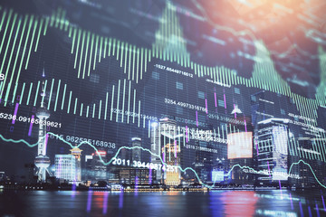 Financial graph on night city scape with tall buildings background double exposure. Analysis concept.