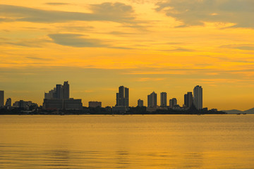Beautiful sunset and modern city with sea font ,Pattaya,Thailand.