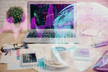 Double exposure of graph and financial info and work space with computer background. Concept of international online trading.