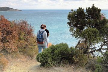 young girls in a hike on the high seashore