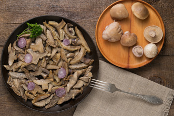 Delicious fried mushrooms in pan on table