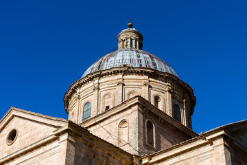 Fototapeta na wymiar The dome of Chiesa di San Biagio, a small Renaissance church in it Montepulciano against the blue sky, Tuscany, Italy.