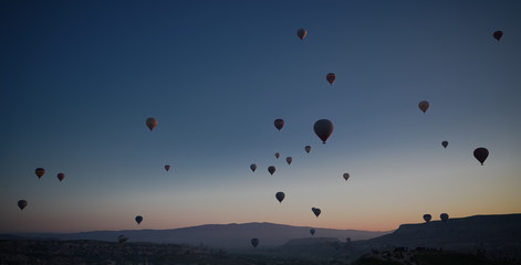 Sunrise panoramic view to Goreme city and flying balloons, Cappadocia, Turkey