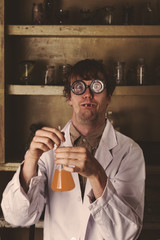 Crazy scientist mixing potions in laborator