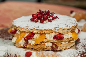 Delicious puff pastry cake, with fresh fruit. Peach, strawberry, apricot and grapes