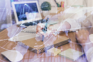 Financial charts displayed on woman's hand taking notes background. Concept of research. Double exposure