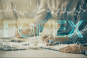 Multi exposure of forex chart with man working on computer on background. Concept of market analysis.