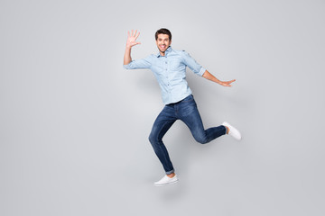 Fototapeta na wymiar Full length body size profile side photo of cheerful excited nice guy wearing footwear aspiring to coming for sales on time isolated over grey color background