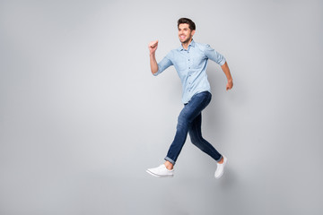 Full length body size photo of cheerful handsome attractive guy wearing white sneakers isolated...