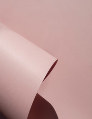 Abstract background in light pastel pink. Paper rolls. Copy space