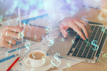 Forex graph with businessman working on computer in office on background. Concept of hardworking. Double exposure.