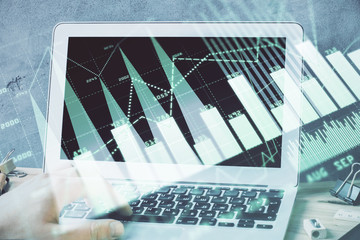 Forex graph with businessman working on laptop on background. Concept of hardworking. Multi exposure.