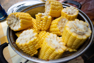 A bowl of fresh corns on a table