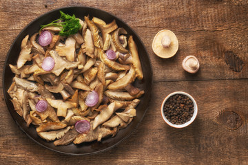 Delicious fried mushrooms in pan on table