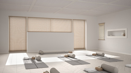 Fototapeta na wymiar Empty yoga studio interior design, open space with mats, pillows and accessories, venetian bamboo blinds, herringbone parquet, big window, ready for yoga practice, meditation room