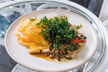 Close up stir fried minced pork with basil and fried egg