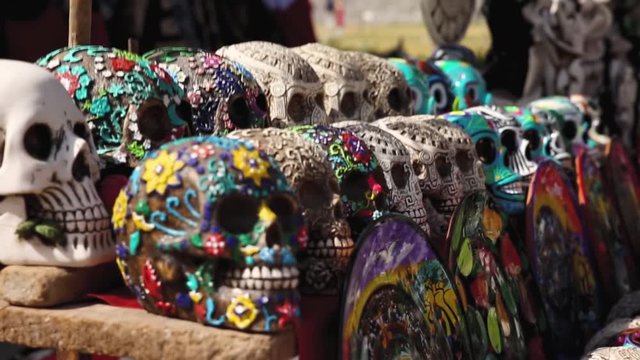 Colorful painted skulls on the table of a shop