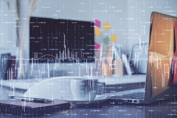 Financial graph colorful drawing and table with computer on background. Double exposure. Concept of international markets.