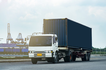 Cargo blue Container truck in ship port Logistics.Transportation industry in port business concept.import,export logistic industrial Transporting Land transport on Port transportation storge 