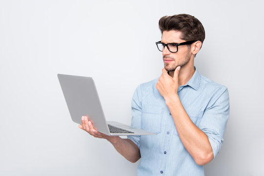 Profile side photo of focused stylish smm expert businessman in spectacles hold use his netbook laptop look think on start-up project wear modern clothes isolated over grey color background