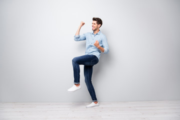 Full body profile side photo of ecstatic man win lottery have victory celebration raise fists scream yeah i am best wear good look style outfit white sneakers isolated over grey color background