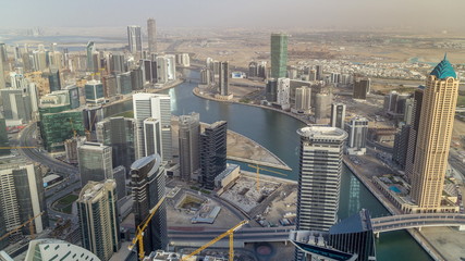 Obraz premium Panoramic aerial view of business bay towers in Dubai at evening timelapse.