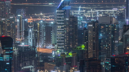 Naklejka premium Panoramic aerial view of business bay towers in Dubai night timelapse.