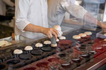Japanese chef cooking sweet snack for show through the window and sale traveler in Dazaifu. Traditional sweet dessert.