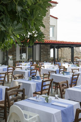 The charming retro Mediterranean outdoor restaurant, no people, empty seats and tables before dinner time