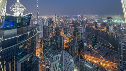 Panoramic aerial view of business bay towers in Dubai day to night timelapse.