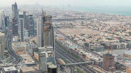 Fototapeta na wymiar Dubai Downtown skyline futuristic cityscape with many skyscrapers and Burj Khalifa aerial night to day timelapse.