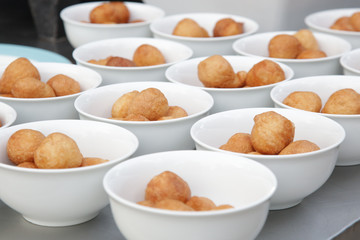 Small fried round donuts in bowls
