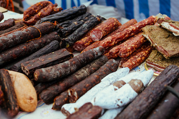 Assortment of spicy dried or smoked beef and pork salami, sausages, chorizo. Various kind types of salami and sausages in market, shop