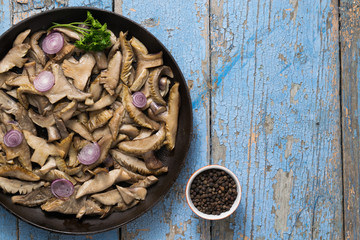 Delicious fried mushrooms in pan on table