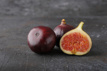 Ripe juicy figs on a dark background.