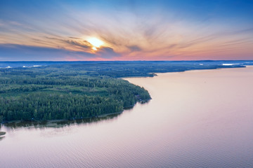Aerial view of Pulkkilanharju Ridge, Paijanne National Park, southern part of Lake Paijanne. Landscape with drone. Blue lakes, fields and green forests from above on a sunset summer day in Finland.