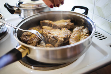 Pork chop is fried in a pan stock photo