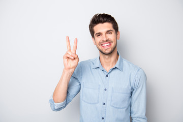 Portrait of positive cheerful guy have fun with his friends on weekend make v-signs wear casual style outfit isolated over grey color background