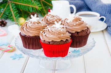 Chocolate cupcakes with cheese chocolate cream with a cup of coffee and marshmallows  for Christmas...