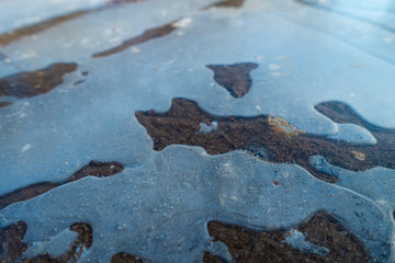 Frozen puddles on mud farm track
