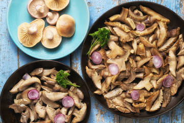 Delicious fried mushrooms in pan on table