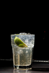 Drink of vodka and lemon slices on the bar, close-up