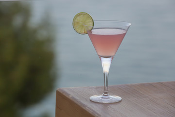 A glass of Cosmopolitan drink on the bar