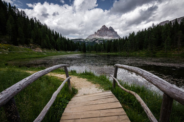 Footbridge over the beautiful alpine lake of Lago di Antorno in the Italian Dolomites